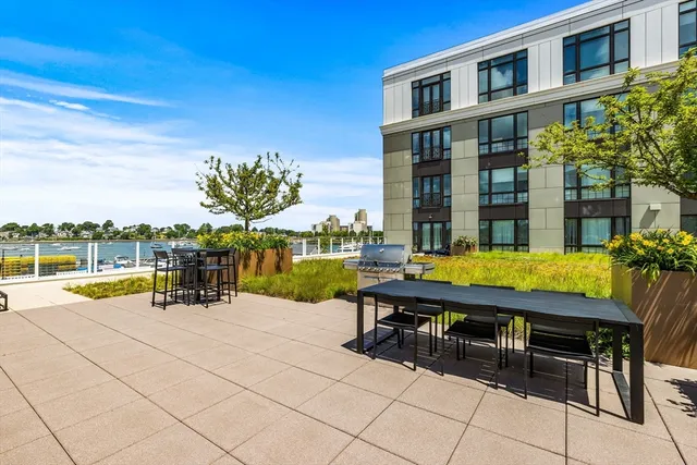 a view of swimming pool with outdoor seating and city view