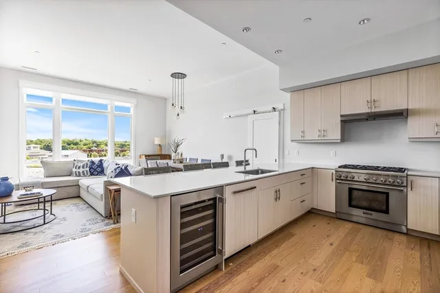 a kitchen with stove a sink and cabinets