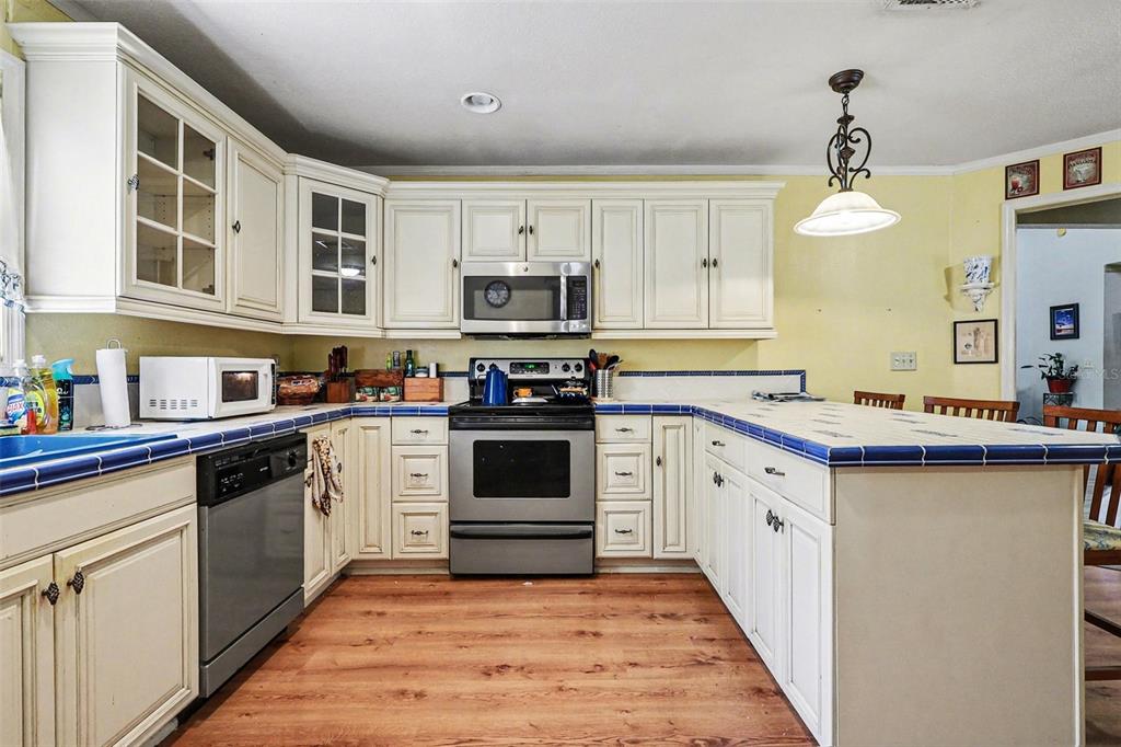 58 Deer Road Frostproof, FL 33843 - Photo 9 of 20 a kitchen with stainless steel appliances granite countertop a stove sink and cabinets