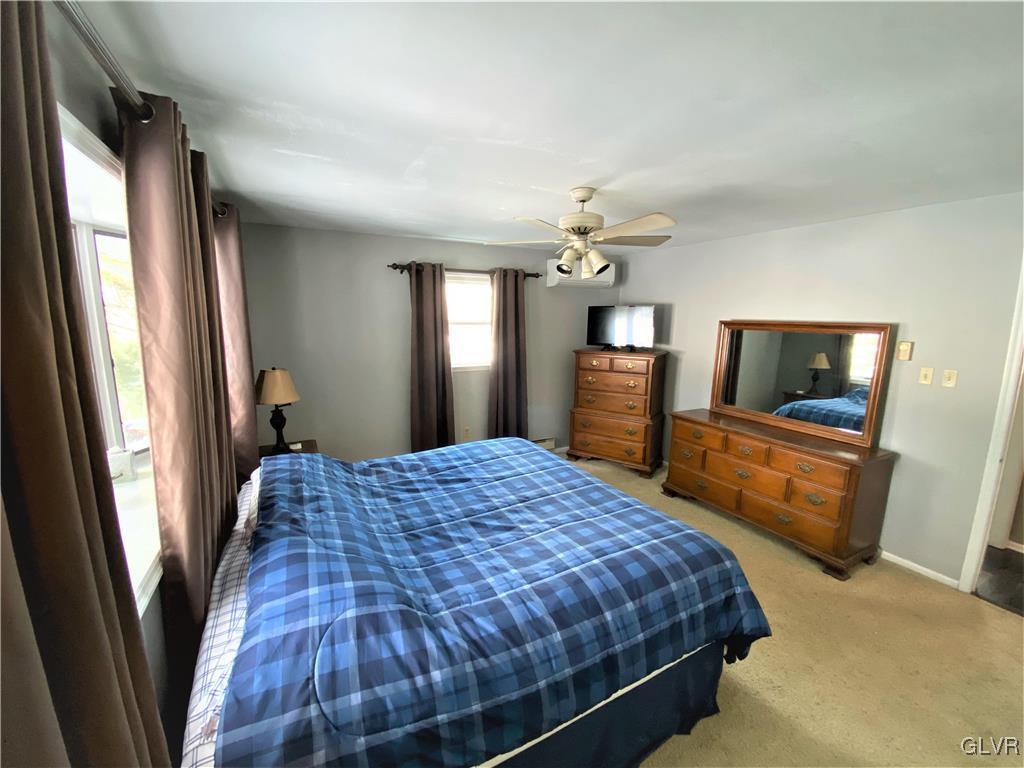 1415 Thomas Drive Coplay, PA 18037 - Photo 13 of 32 a bedroom with a bed and a mirror on dresser