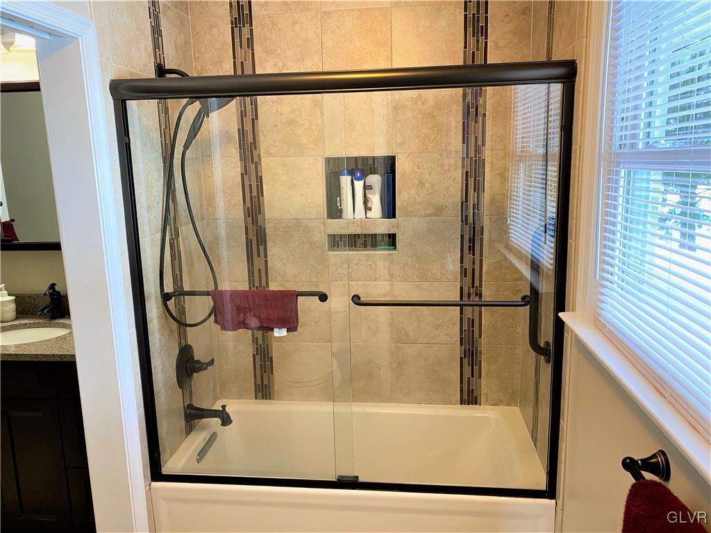 1415 Thomas Drive Coplay, PA 18037 - Photo 17 of 32 a bathroom with a bathtub and a shower