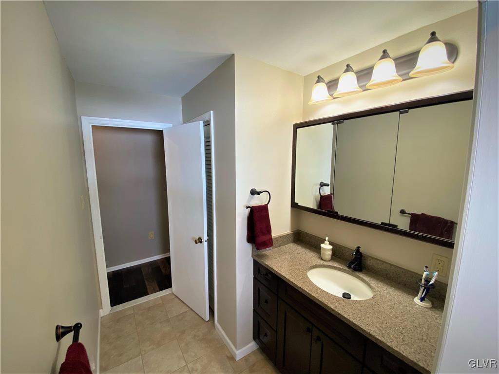 1415 Thomas Drive Coplay, PA 18037 - Photo 18 of 32 a bathroom with a granite countertop sink and a mirror