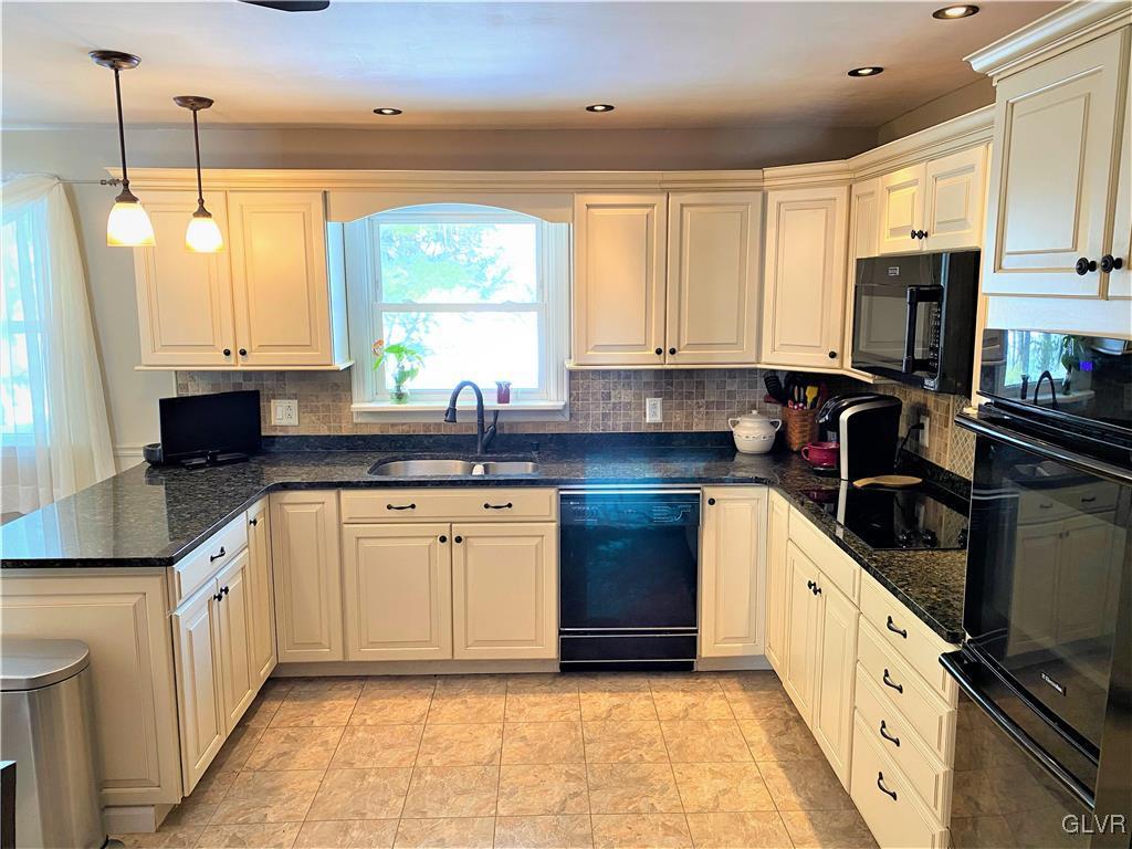 1415 Thomas Drive Coplay, PA 18037 - Photo 3 of 32 a kitchen with granite countertop a sink a counter top space appliances and cabinets