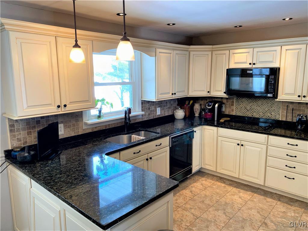 1415 Thomas Drive Coplay, PA 18037 - Photo 4 of 32 a kitchen with stainless steel appliances granite countertop a sink a stove and a microwave