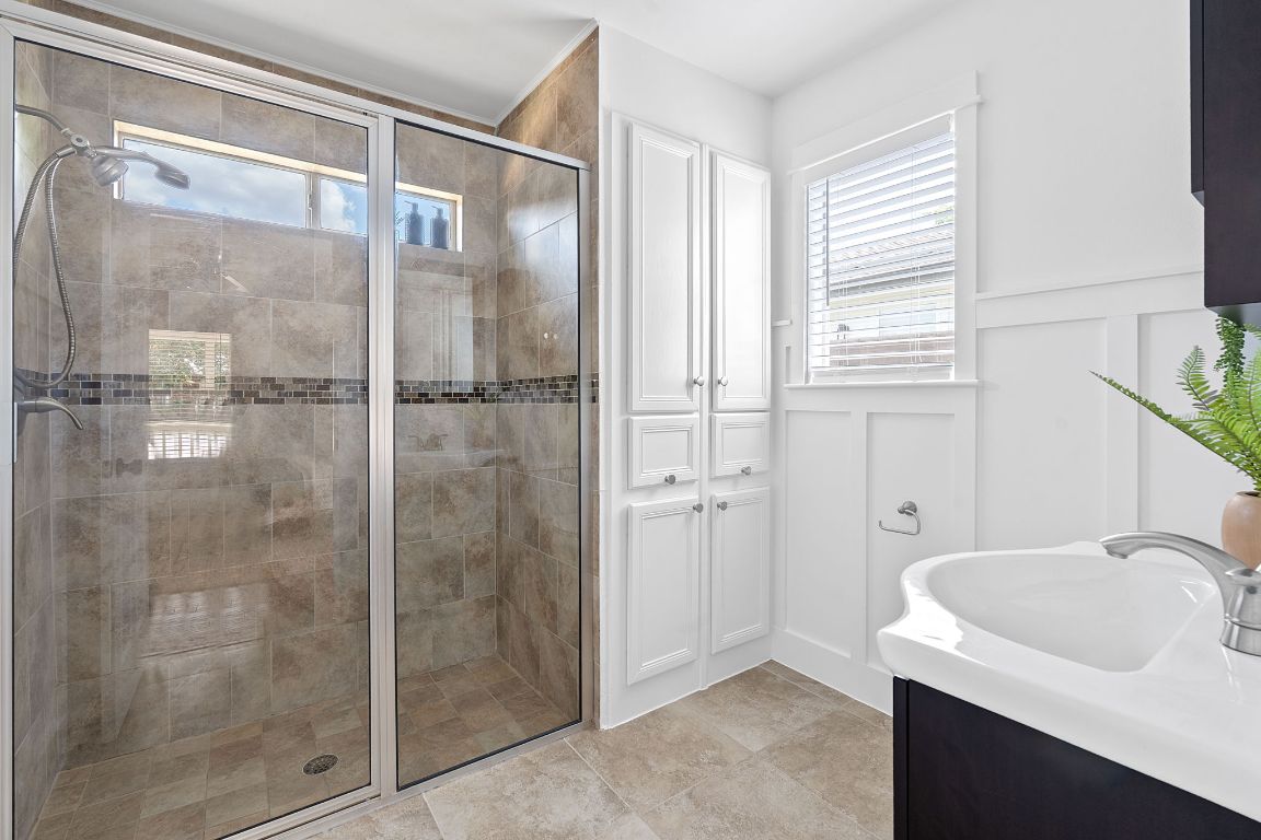 3404 Thomas Kincheon Street, Unit 1 & 3 Austin, TX 78745 - Photo 15 of 30 a bathroom with a sink and shower