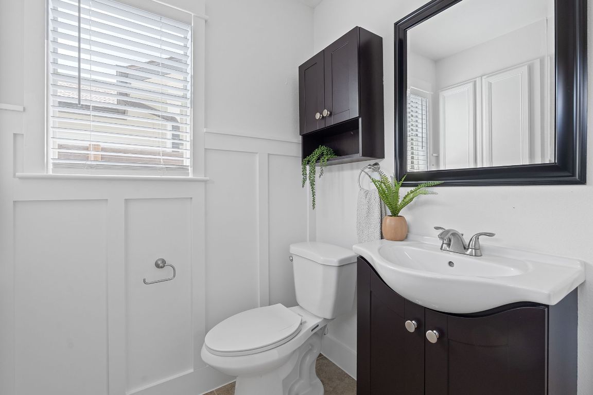 3404 Thomas Kincheon Street, Unit 1 & 3 Austin, TX 78745 - Photo 16 of 30 a bathroom with a sink a toilet and mirror