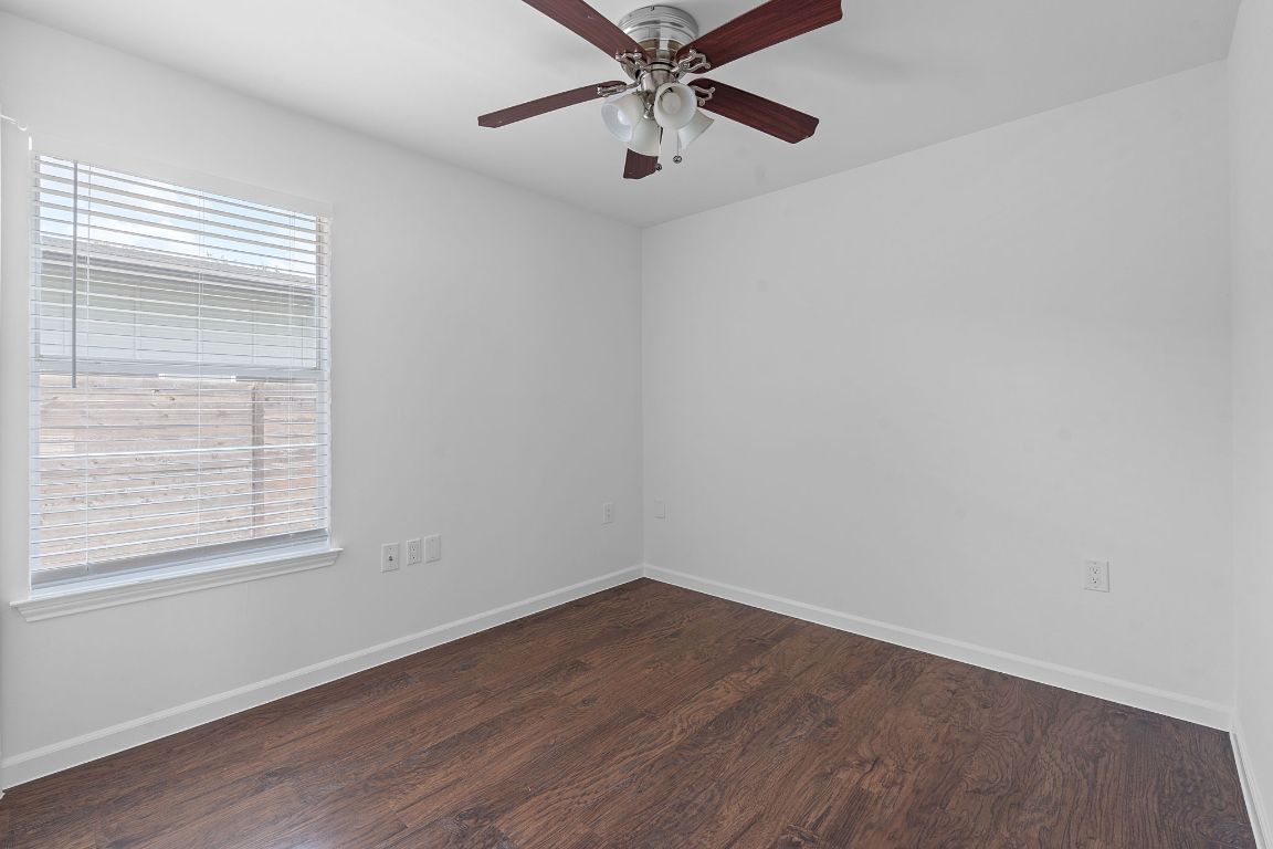3404 Thomas Kincheon Street, Unit 1 & 3 Austin, TX 78745 - Photo 17 of 30 wooden floor in an empty room with a window