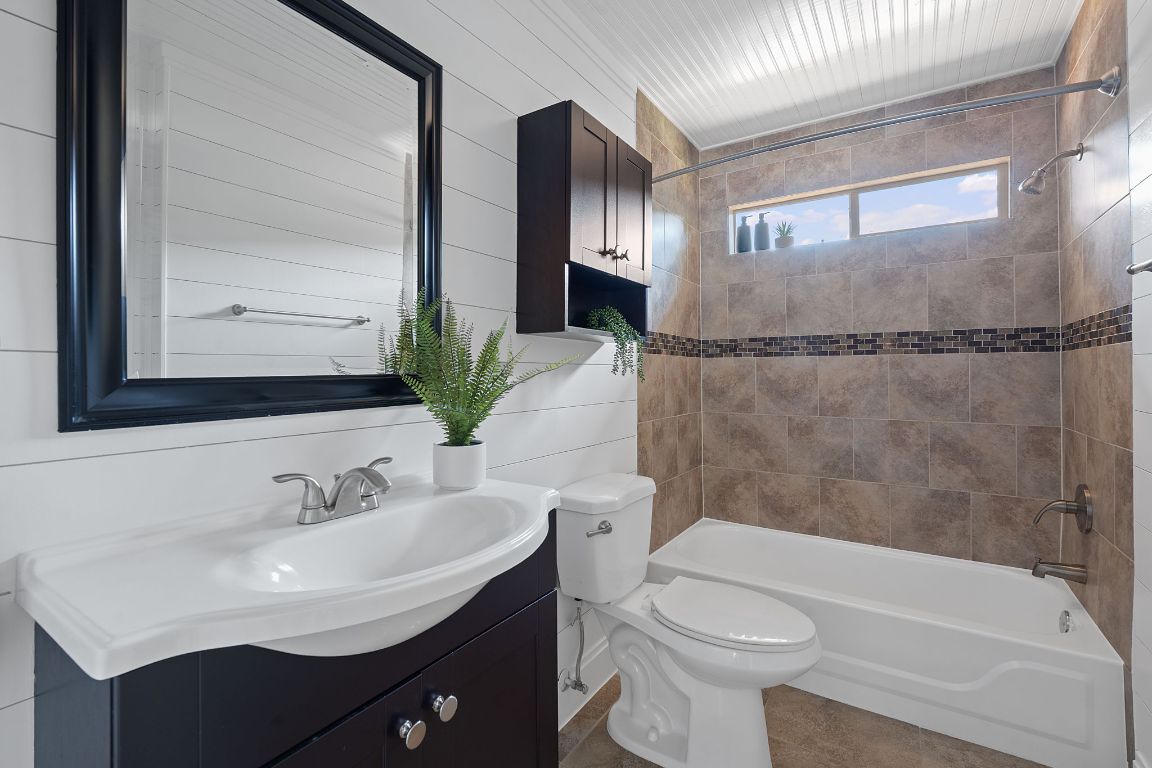 3404 Thomas Kincheon Street, Unit 1 & 3 Austin, TX 78745 - Photo 18 of 30 a bathroom with a sink toilet and shower