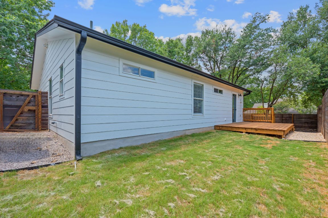 3404 Thomas Kincheon Street, Unit 1 & 3 Austin, TX 78745 - Photo 19 of 30 a view of a backyard with table and chairs and wooden fence