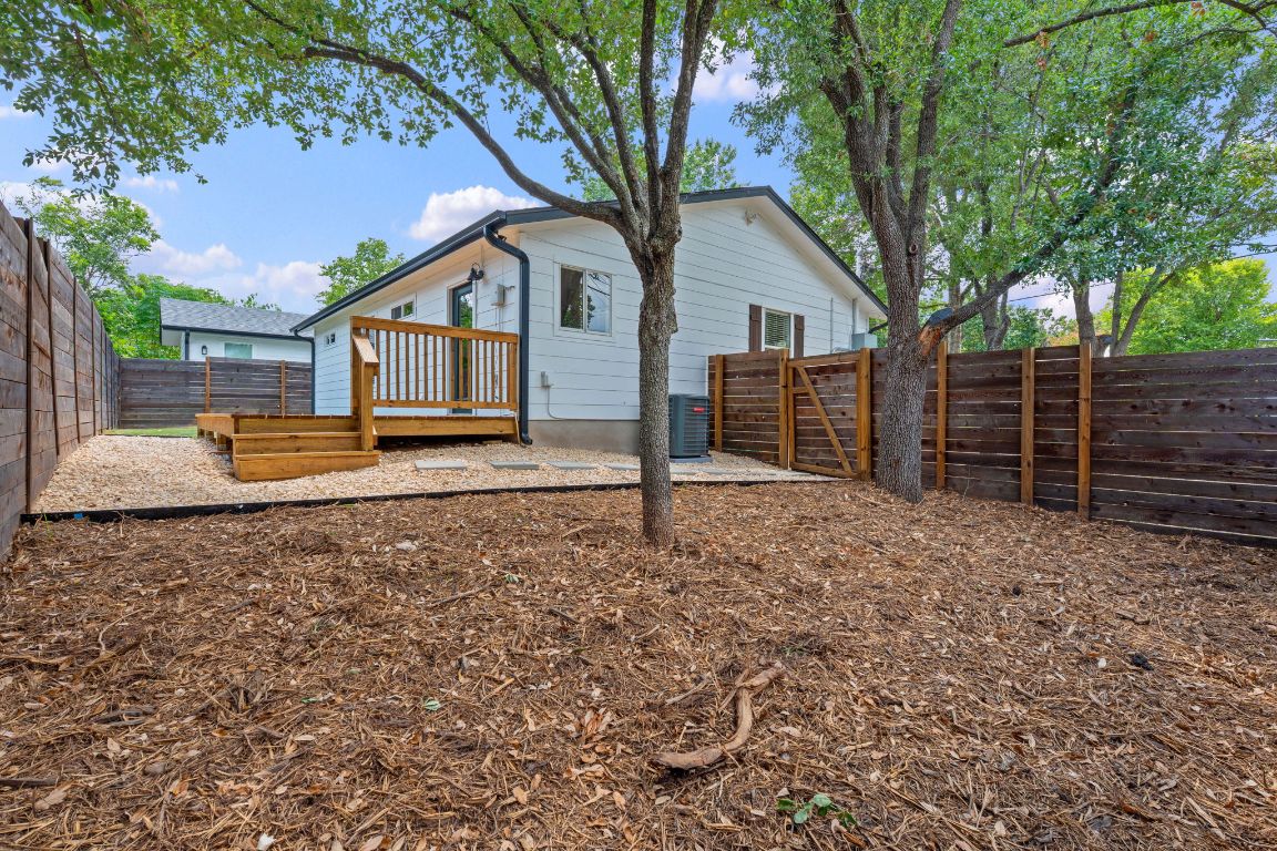 3404 Thomas Kincheon Street, Unit 1 & 3 Austin, TX 78745 - Photo 21 of 30 a house with wooden fence and large trees