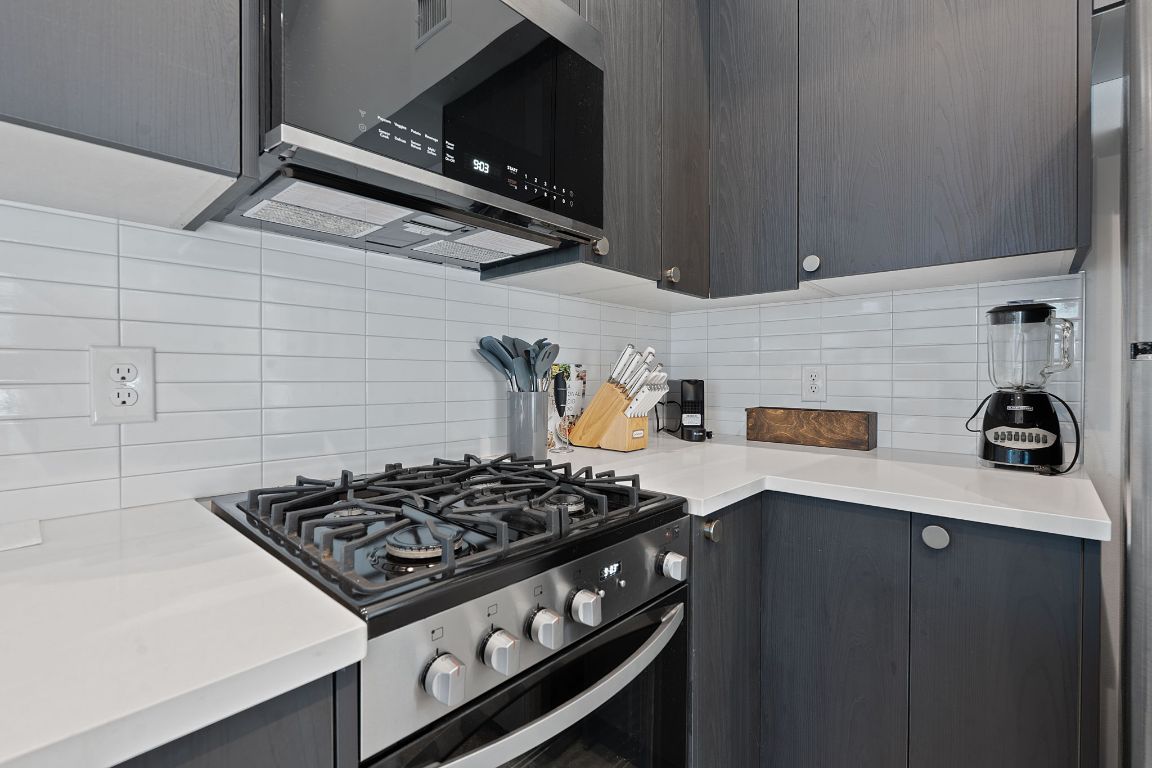 3404 Thomas Kincheon Street, Unit 1 & 3 Austin, TX 78745 - Photo 25 of 30 a stove top oven sitting inside of a kitchen