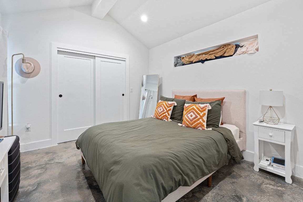 3404 Thomas Kincheon Street, Unit 1 & 3 Austin, TX 78745 - Photo 27 of 30 a bedroom with a bed and a chandelier