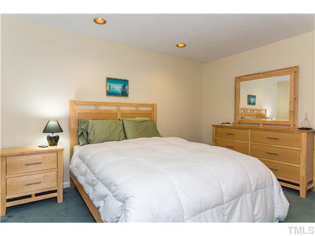 49 Stoneridge Road Durham, NC 27705 - Photo 8 of 14 a bedroom with a bed and a dresser