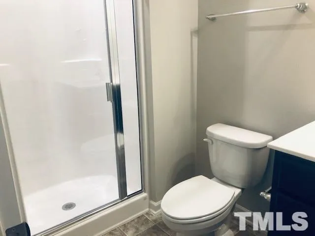 a white toilet sitting next to a bathroom sink