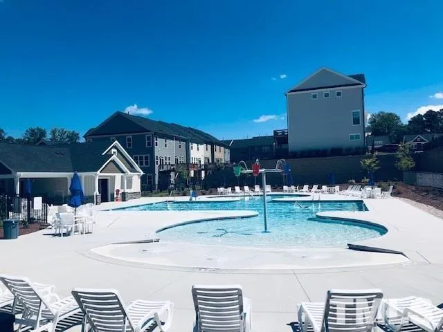 a view of a house with a yard and sitting area