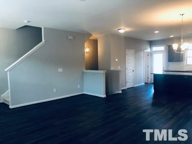 a view of a kitchen with wooden floor and a sink