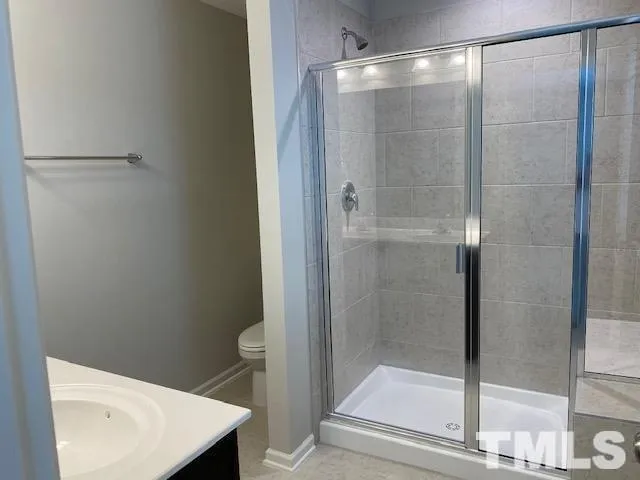 a bathroom with a shower and toilet