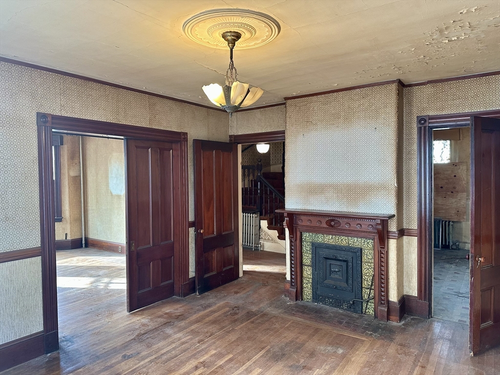 183 Temple Street Boston, MA 02132 - Photo 5 of 15 a view of an entryway with a fireplace cabinet and window