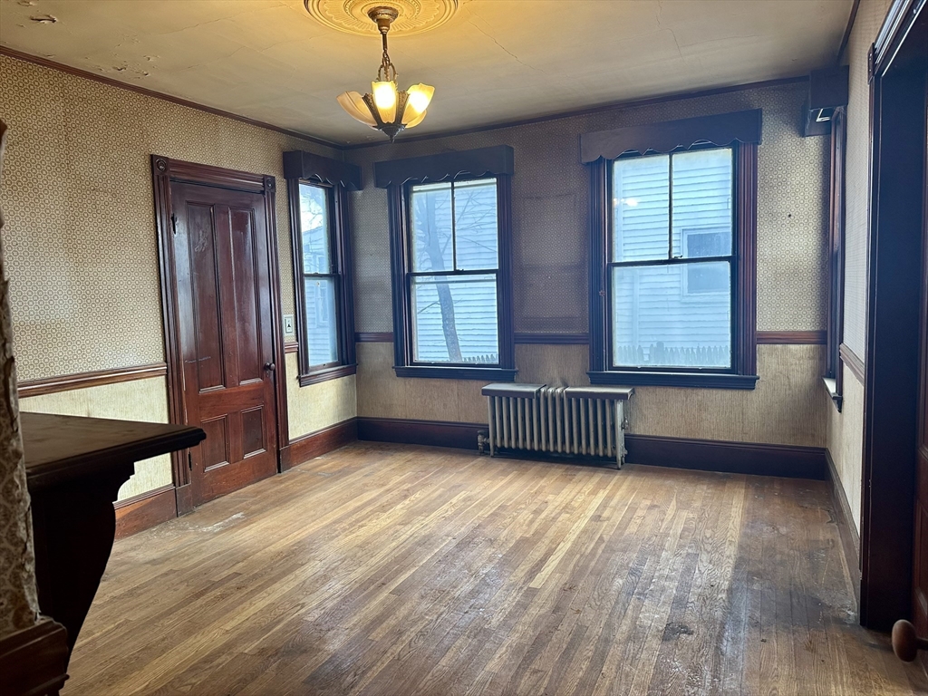 183 Temple Street Boston, MA 02132 - Photo 6 of 15 wooden floor and windows in an empty room with a window