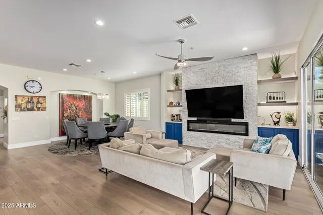 a living room with furniture a dining table and a large window
