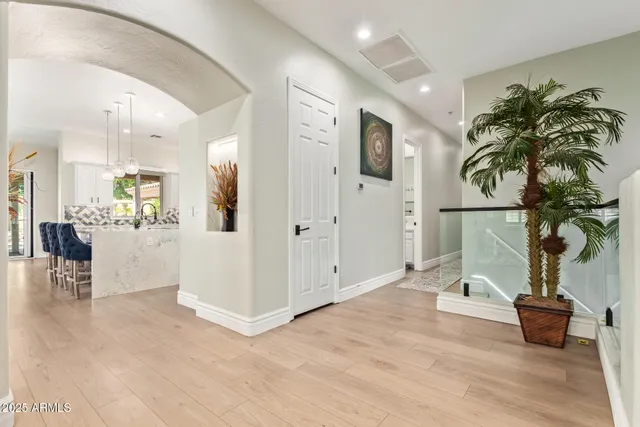 a kitchen with stainless steel appliances kitchen island granite countertop a sink and refrigerator