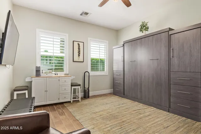 a bathroom with a granite countertop sink a toilet and shower