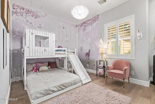 a view of a patio with table and chairs under an umbrella