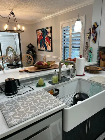 a kitchen with a sink a counter and cabinets