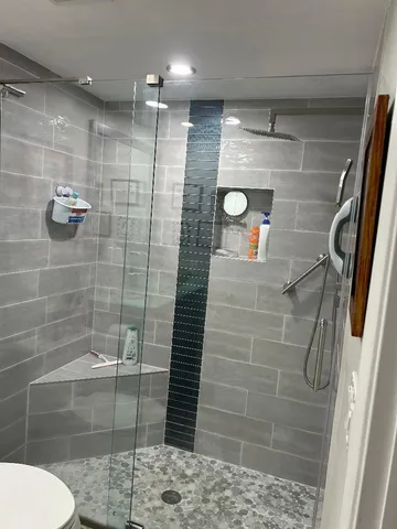 a bathroom with a shower and toilet