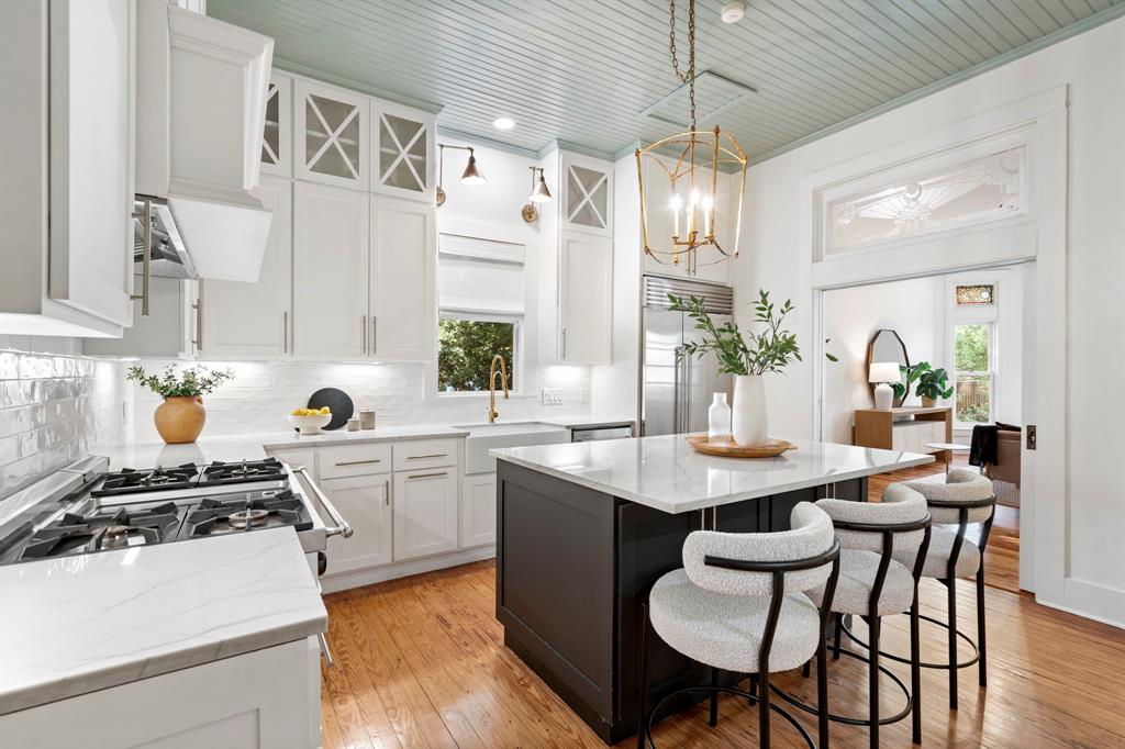 1502 West Virginia Street McKinney, TX 75069 - Photo 11 of 40 a kitchen with a dining table chairs sink and stove
