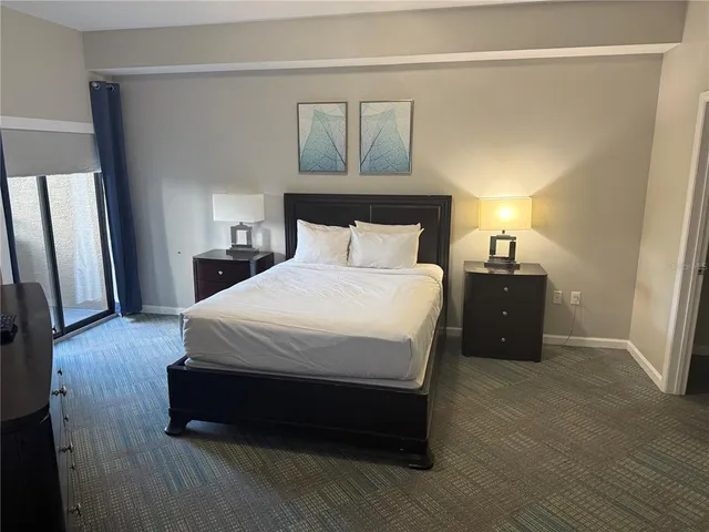 a bedroom with a bed and a television