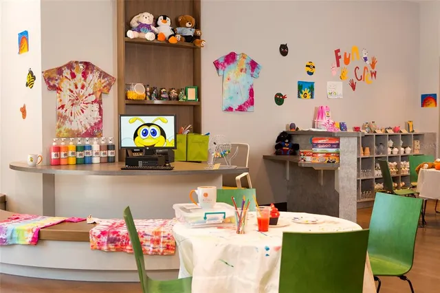 an outdoor sitting area with chairs and umbrella