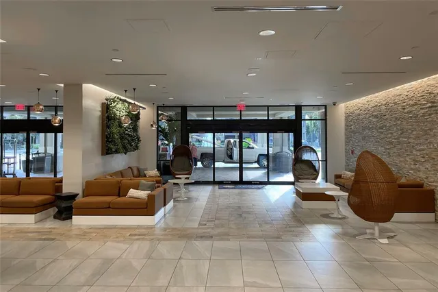 a living room with furniture a large window and a fireplace