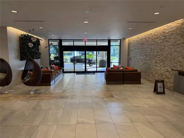 a lobby with furniture and window
