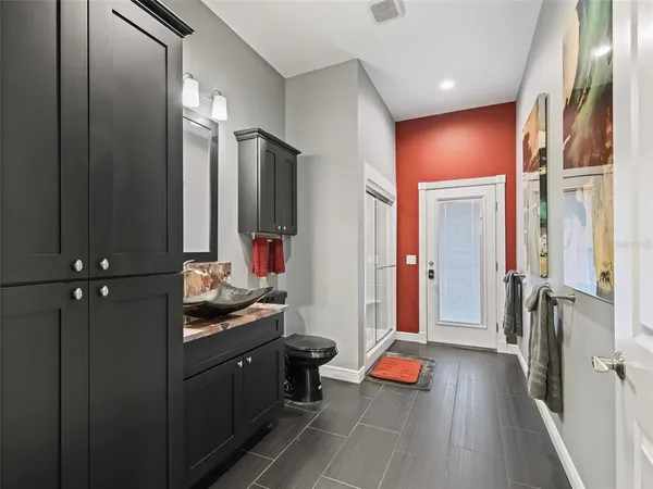 a kitchen with granite countertop a sink stove and cabinets