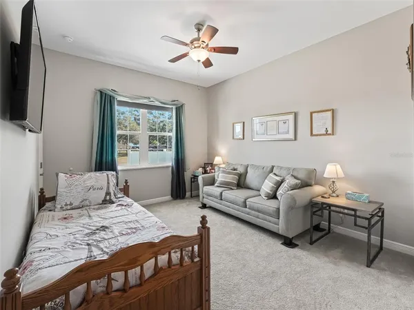 a bedroom with a large bed and a flat tv screen
