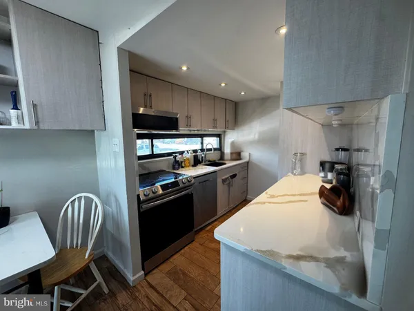a kitchen with a sink a stove and chairs
