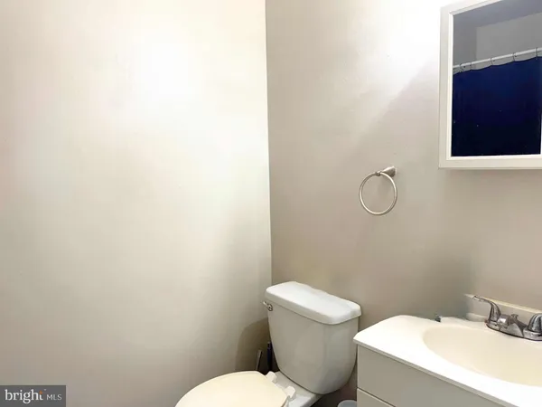 a white toilet sitting next to a bathroom sink