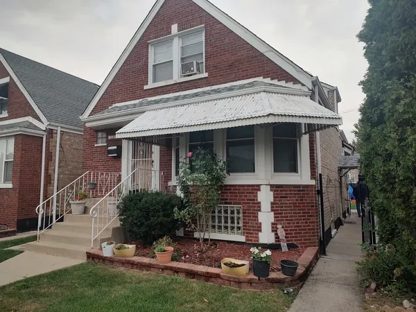 a view of house with yard and outdoor seating