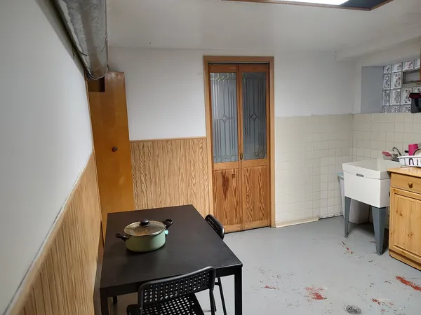 a kitchen with refrigerator and cabinets