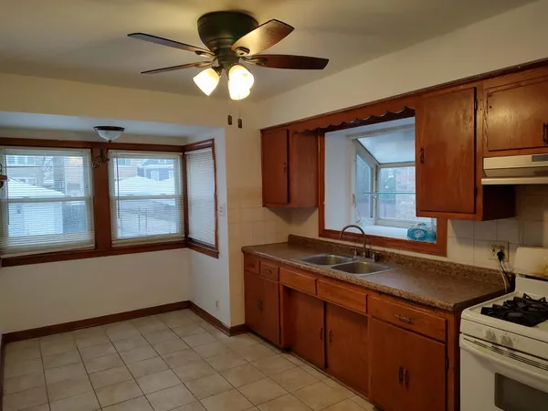a kitchen with a cabinets a sink and a stove