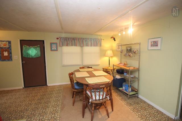 89 Haylee Road Waverly, TN 37185 - Photo 1 of 6 a view of a dining room with furniture and a window