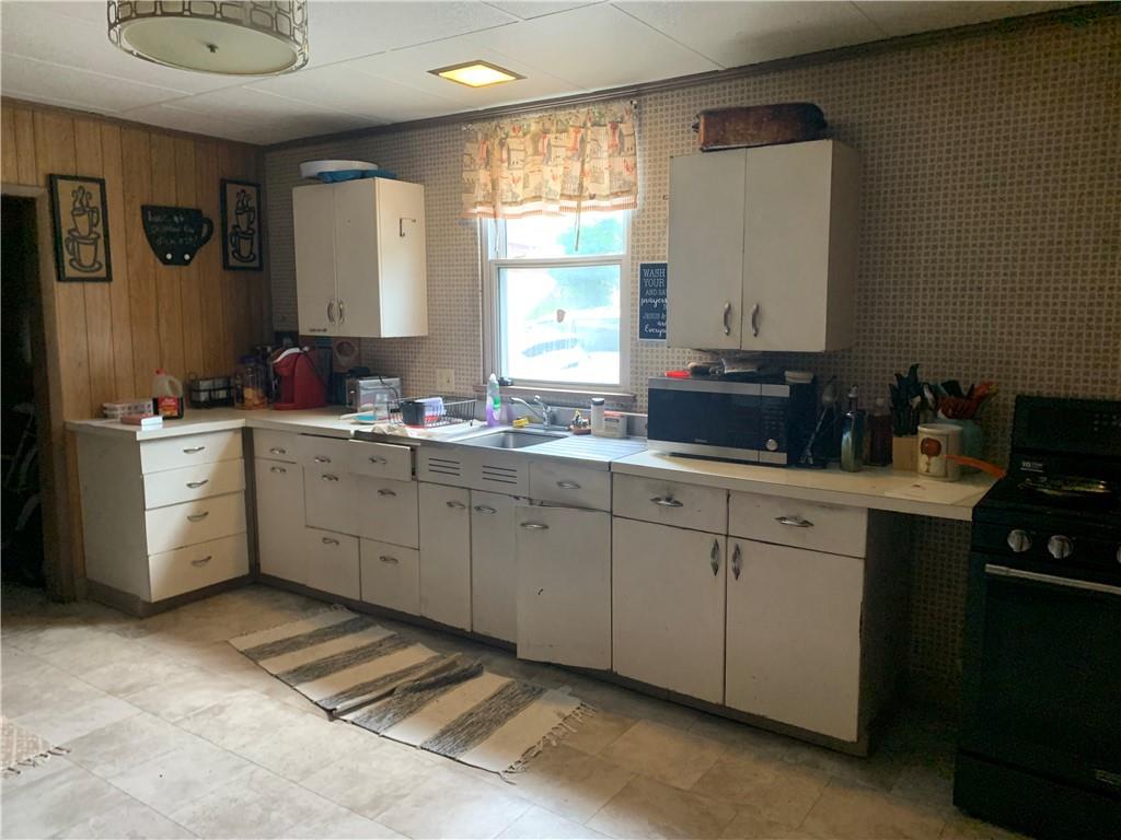 511 Virginia Avenue Rochester, PA 15074 - Photo 11 of 19 a kitchen with a sink cabinets and window