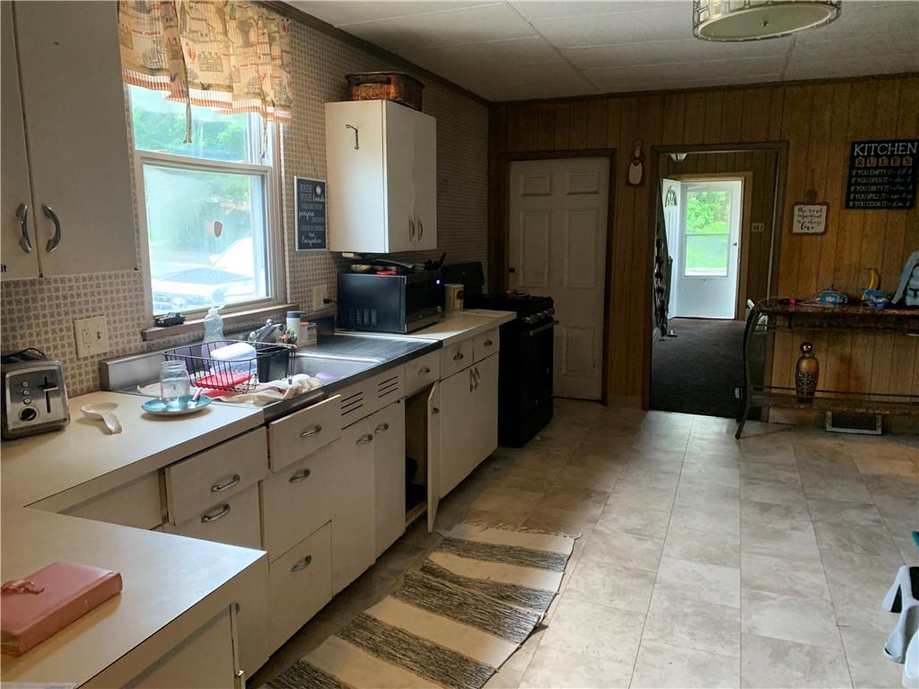 511 Virginia Avenue Rochester, PA 15074 - Photo 12 of 19 a kitchen with stainless steel appliances a sink stove and cabinets