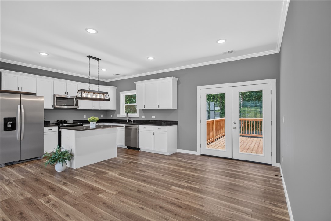 223 Maple Drive Anderson, SC 29621 - Photo 14 of 45 A contemporary kitchen space boasts abundant storage, sleek countertops, and convenient deck access.