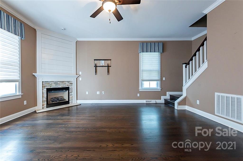 535 Fourth Baxter Crossing Fort Mill, SC 29708 - Photo 12 of 23 a view of an empty room with window and wooden floor