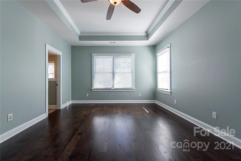 535 Fourth Baxter Crossing Fort Mill, SC 29708 - Photo 13 of 23 an empty room with wooden floor fan and windows
