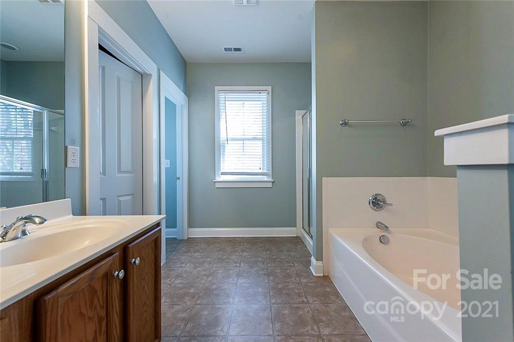 535 Fourth Baxter Crossing Fort Mill, SC 29708 - Photo 14 of 23 a bathroom with a bathtub sink and mirror