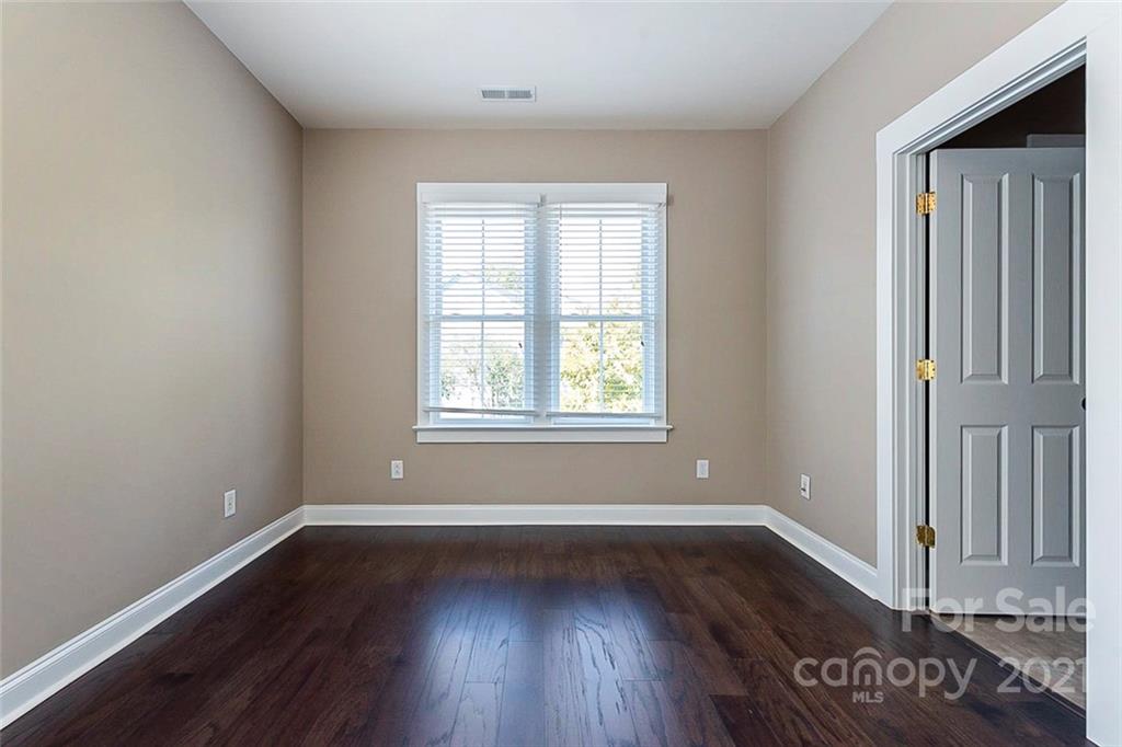 535 Fourth Baxter Crossing Fort Mill, SC 29708 - Photo 18 of 23 an empty room with wooden floor and windows