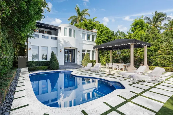 a view of a house with backyard porch and sitting area